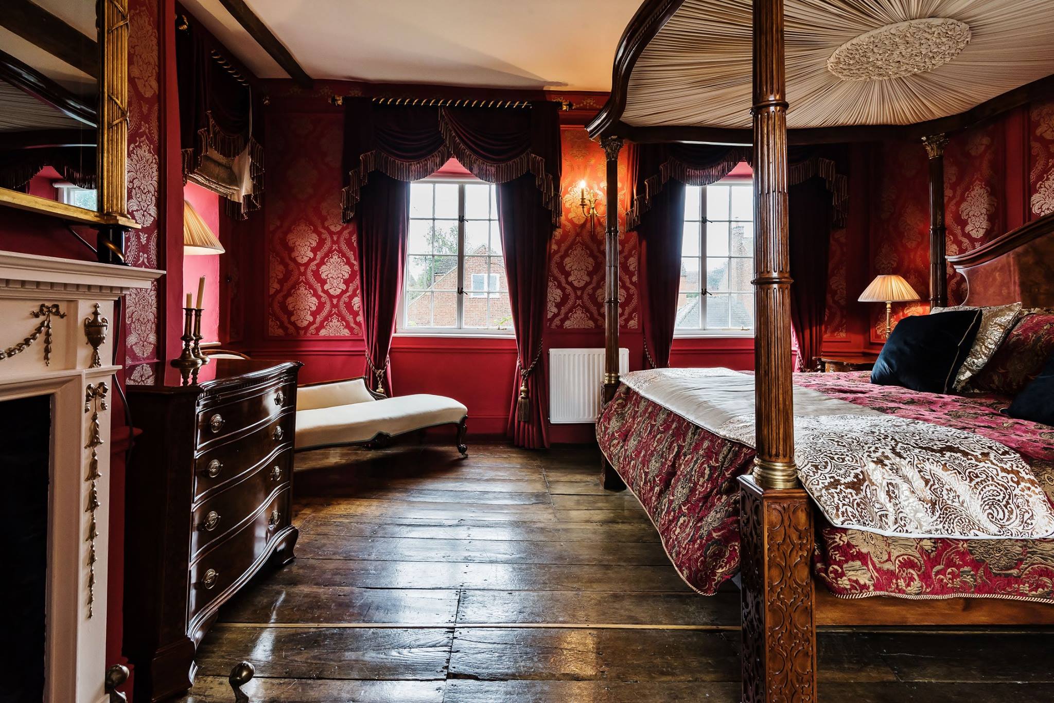 The Red Bedroom with Open Twist Curtain Poles and Acanthus &amp; Flambeau Finials by Edward Harpley