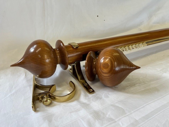 Pine tracked pole with brass brackets and pine finials